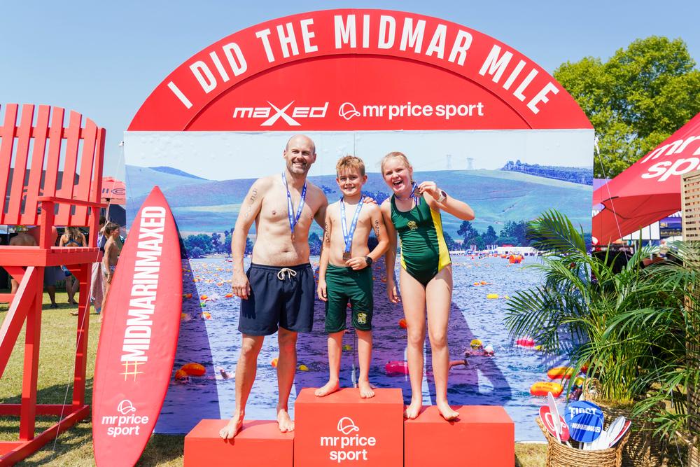 Father and two children with medals on the podium